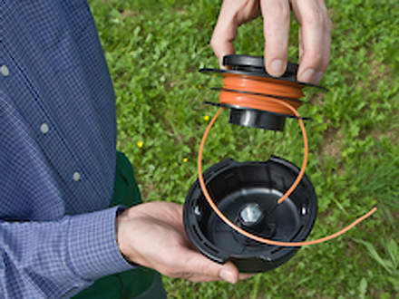 : Step 4 of 6: Inserting the spoolHold the spool over the mowing head. Thread the ends of the lines through the holes in the mowing head and then pull the line out of the openings in the spool. Push the lines through to the outside and then insert the spool in the mowing head.